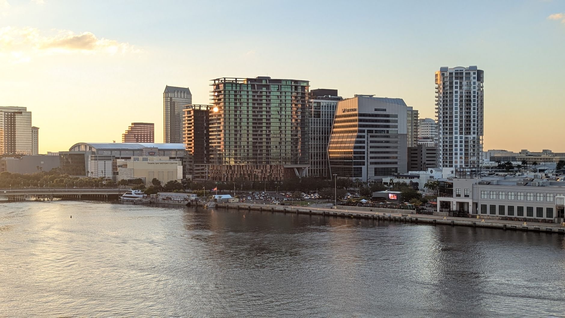 A stunning view of Tampa's skyline reflecting on the water at sunset.